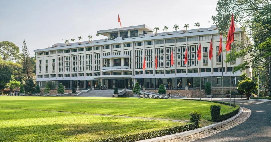 A university depicting IIT Delhi’s main academic building with red flags and lush green lawn