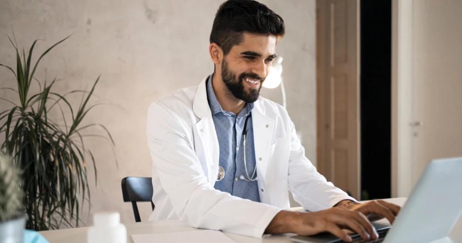 Candidate selecting exam city for NEET PG 2025 on laptop