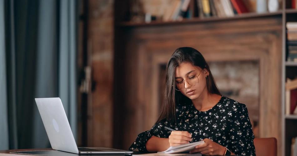 Student applying for CUET UG 2025 Accountancy re-test with laptop and notes