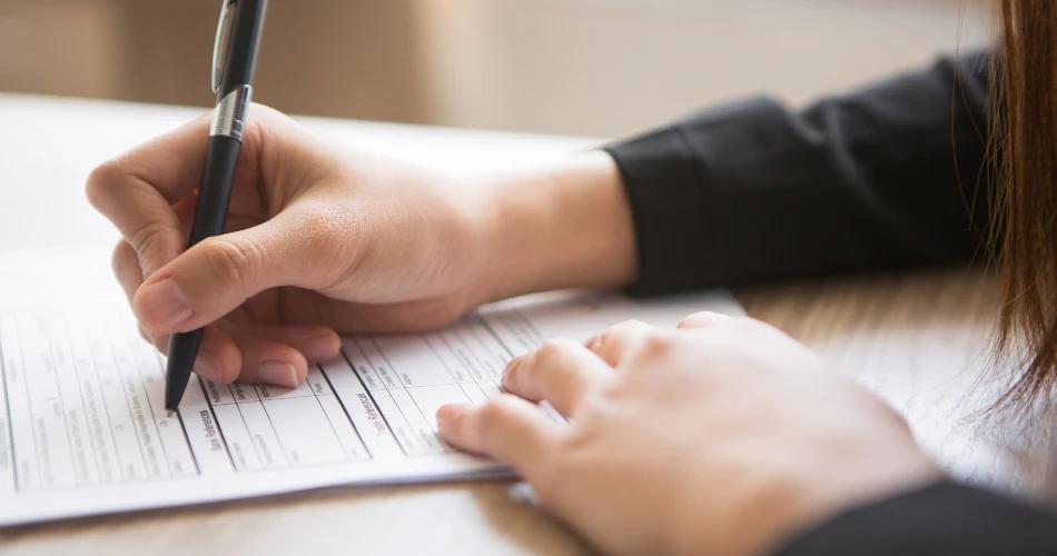 A student writing notes indicating HSC Supplementary Exams 2025 timetable urgency.