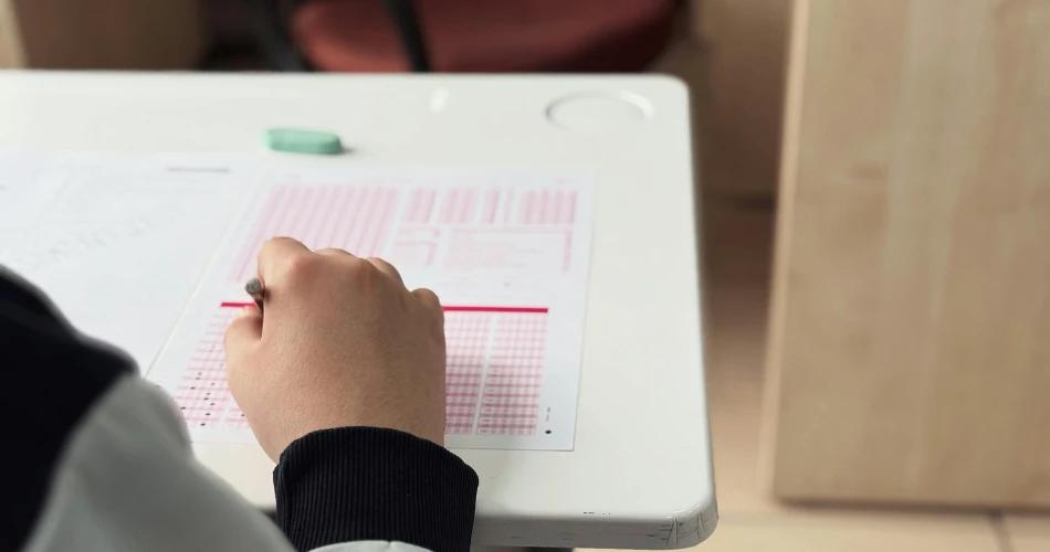 Student filling OMR answer sheet during CUET UG 2025 exam – image representing the CUET provisional answer key release by NTA