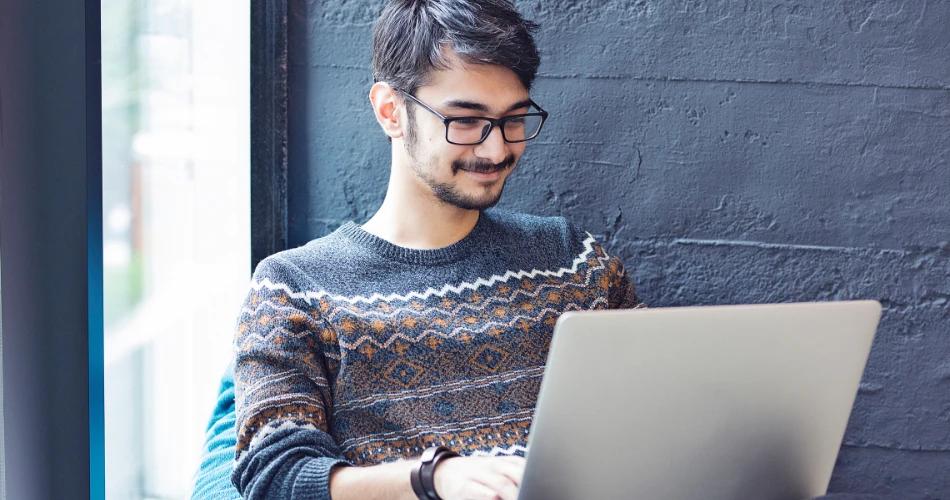 Student checking CUET UG 2025 Accountancy re-test admit card online on a laptop.