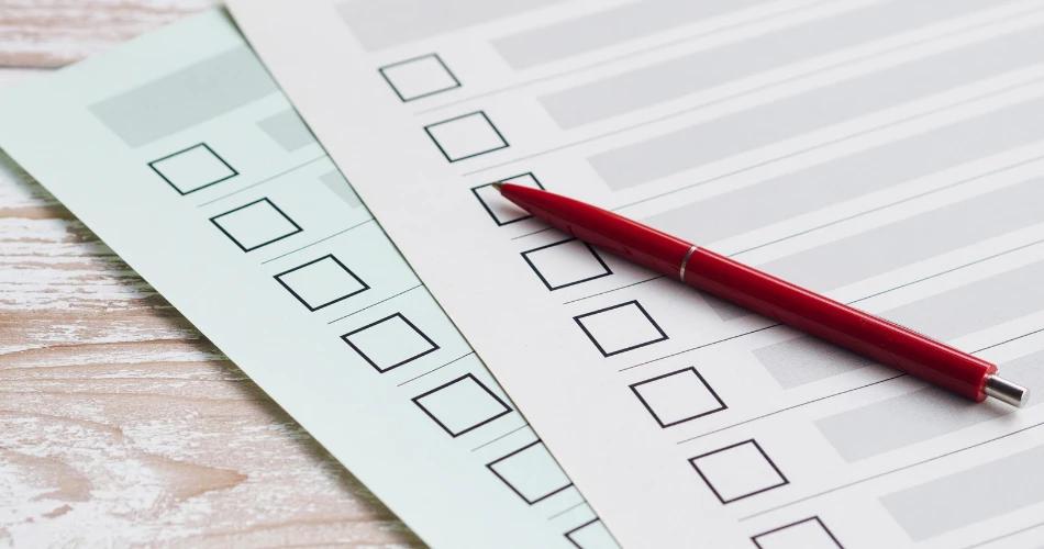 Candidate checking answers on JEE Main Session 2 Paper 2 provisional answer key sheet with pen