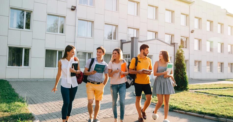 Group of students walking on campus with books in hand, symbolizing Maharashtra Class 11 (FYJC) Admission 2025 process and registration.