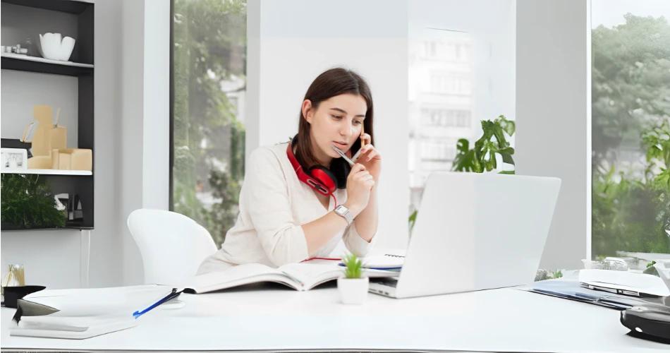 CBSE professional offering remote psychosocial counselling over the phone while working from home on a laptop